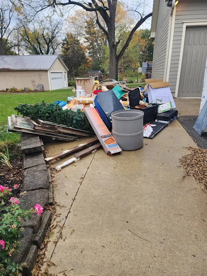 Dumpster being loaded with debris for 3 Yard Dumpster Rental in North Liberty